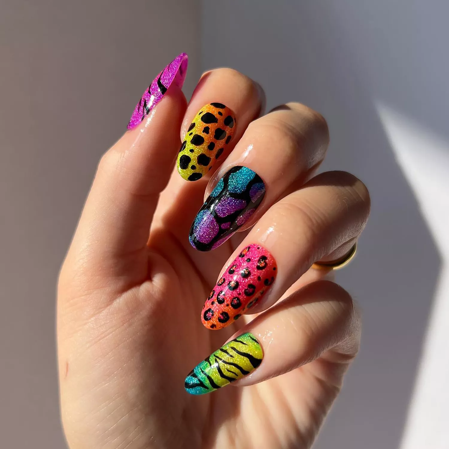 Lisa Frank-themed manicure with cheetah and zebra prints