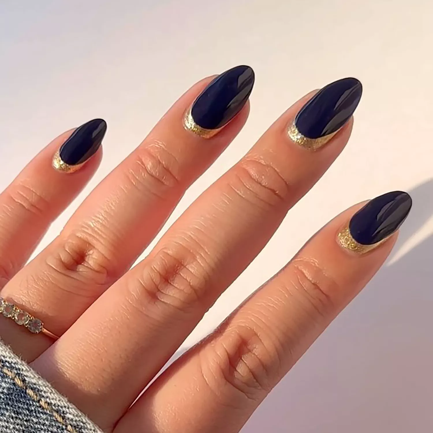 55+ Winter Nail Design Ideas 2025 22 A navy blue manicure with gold details at the cuticle