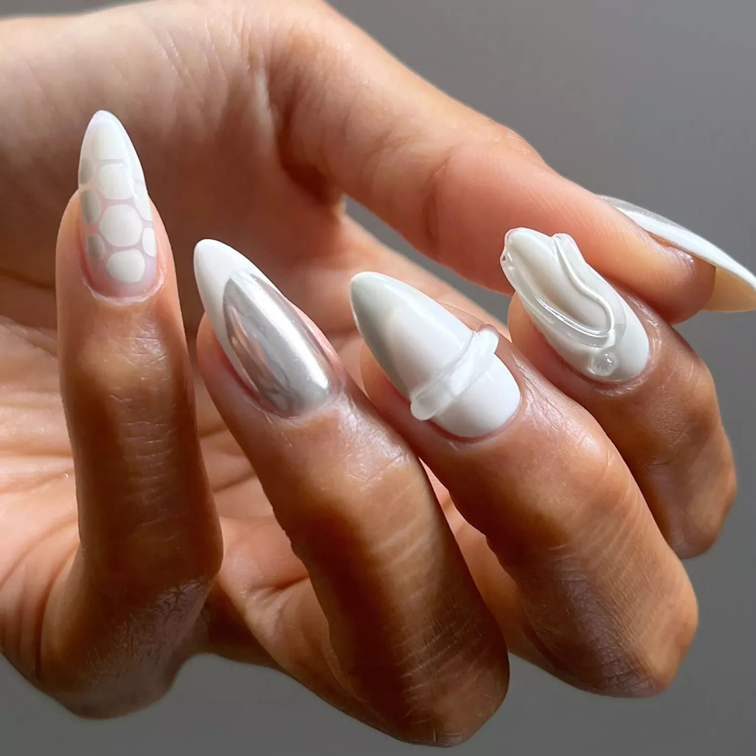 55+ Winter Nail Design Ideas 2025 15 A white mismatched manicure with builder gel and chrome details