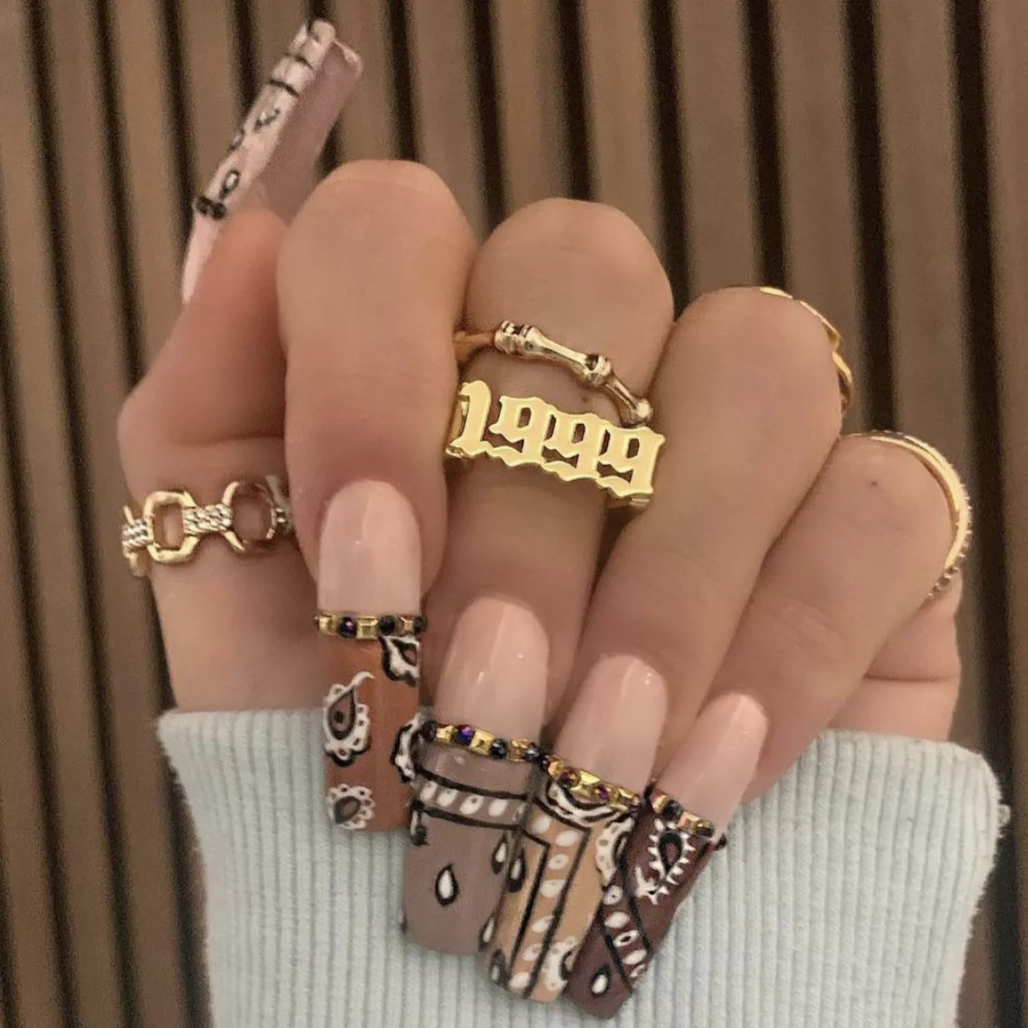 Long square-shaped nails with bandana-print tips in various brown shades