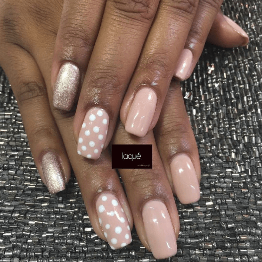 Pink square nails with white dots