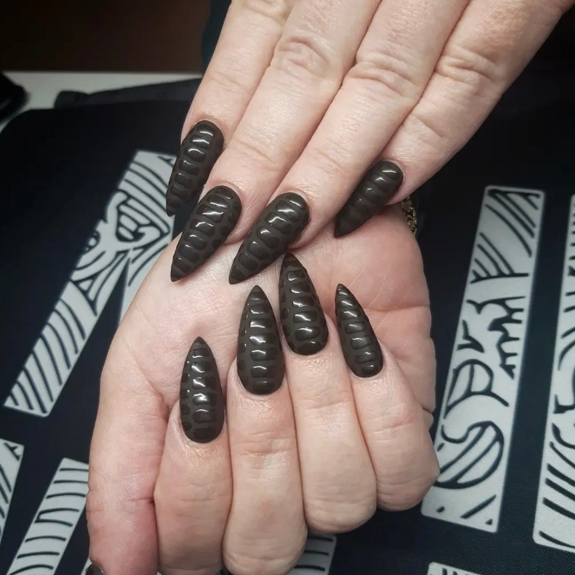 Black 3D nail art with shiny and matte polish